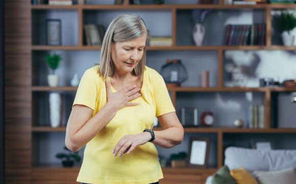 Older woman at home doing fitness has severe shortness of breath and chest pain, compares bullets on